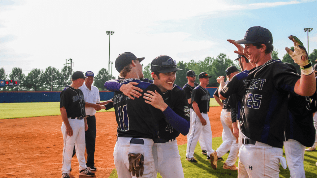 Base ball team hugging g each other